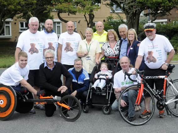 A group of cyclists are riding from Scarborough to Blackpool to raise money for Brian House. They are pictured with supporters and staff from Brian House