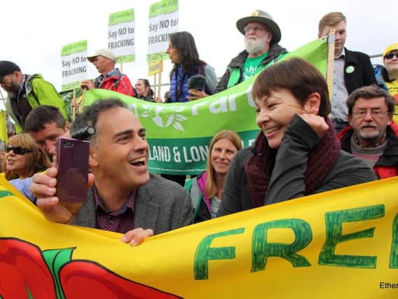 Green Party leaders Jonathan Bartley and Caroline Lucas sitting down at the gates of Cuadrilla's fracking site at Preston New Road to show solidarity with local protesters. Photo by Ross Wills, Maple Indie Media.