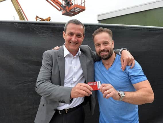 Fleetwood chairman Andy Pilley gives singing sensation his new Onward Card after his Homecoming concert at Highbury