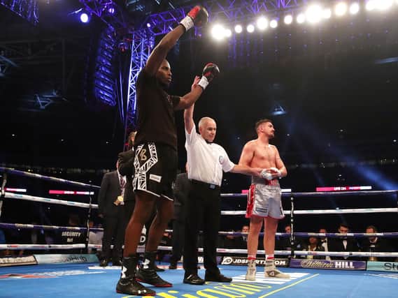 Okolie's hand is raised after a messy 12 rounds