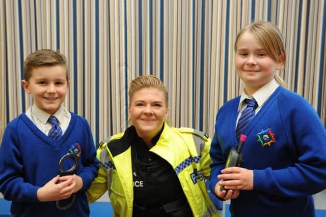 PC Claire van Deurs Goss with year five pupils Lewis Thorne and Libby Johnson
