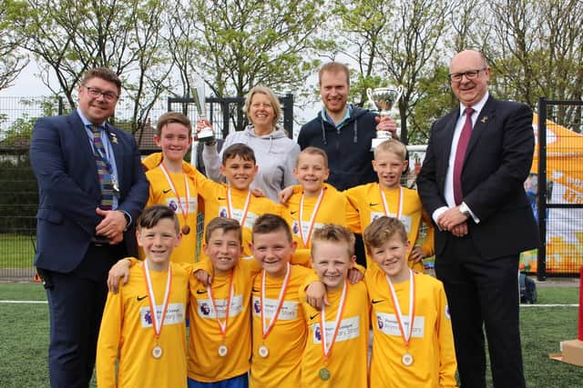 Anchorsholme Primary Academy won the tournament. The players are pictured with Armfield Academy headteacher Mark Kilmurrary (left) and Duncan Armfield, son of Jimmy (right).