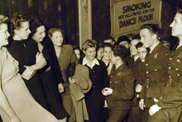 Claire Parker, centre, with pals chatting to airmen in the Tower Lounge, Blackpool, in 1942