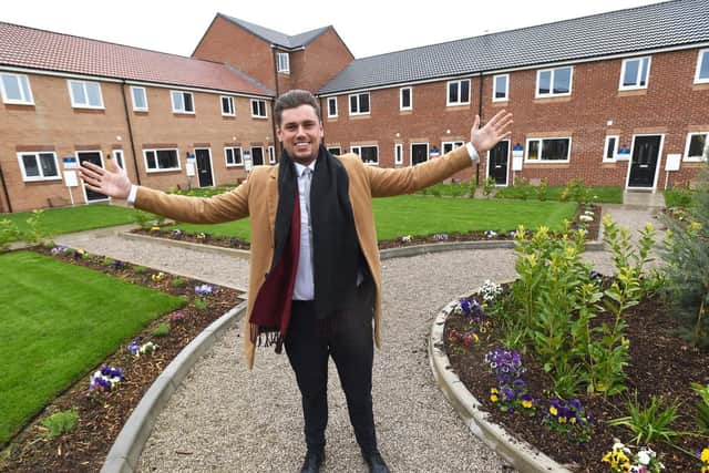 Wesley Liptrott shows off the newly landscaped site where people are already moving in