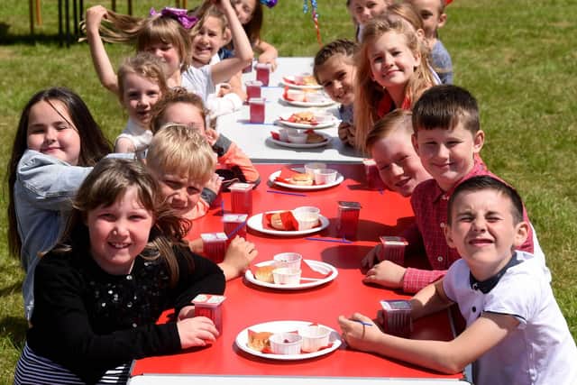 Kincraig youngsters get ready to tuck in during the school's tea party to celebrate the Queen's reign.