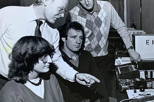 Using computer interfacing equipment. From left: Lynne Wade, Bert Clough, Paul Spearman and Steve Walthew.