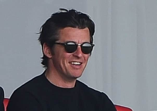 Joey Barton watches Fleetwood Town's match with Wigan Athletic
