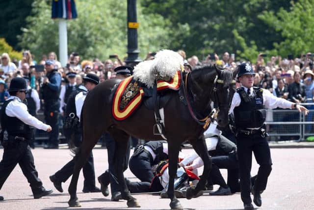 Officers attending to Field Marshal Lord Guthrie of Craigiebank, the former head of the armed forces, who is in hospital after falling from his horse following the Trooping the Colour ceremony. Photo: PA/PA Wire