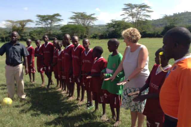Mrs Kirsty Randles from Haw Side Academy joins in a sports lesson with pupils from Barat Primary School in Kenya