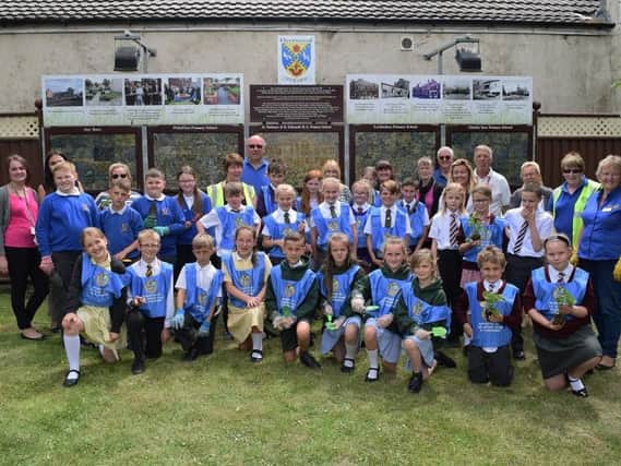 Fleetwood school children who are part of Rotakids have planted summer blooms in tubs and baskets at the town's Pocket Park