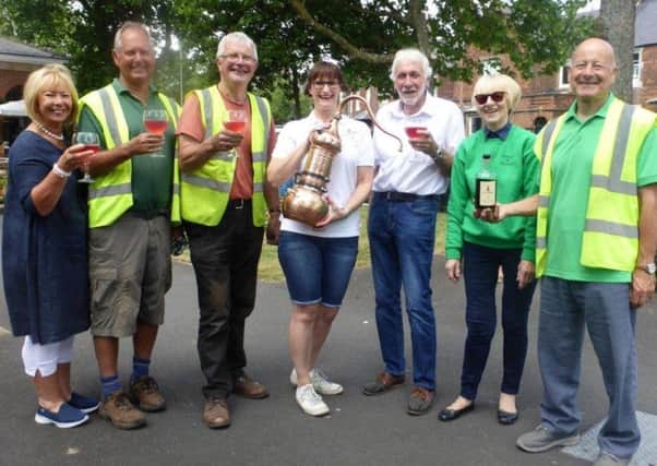 Sara Dewhurst of Lytham Gin (centre) gives Lytham In Bloom volunteers their first taste of the specially-distilled In Bloon Gun