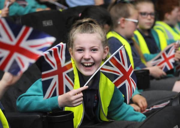 Schoool children take part in Going to the Flicks for Armed Forces Week at the Odeon cinema.  Revoe pupils wave the flag.
