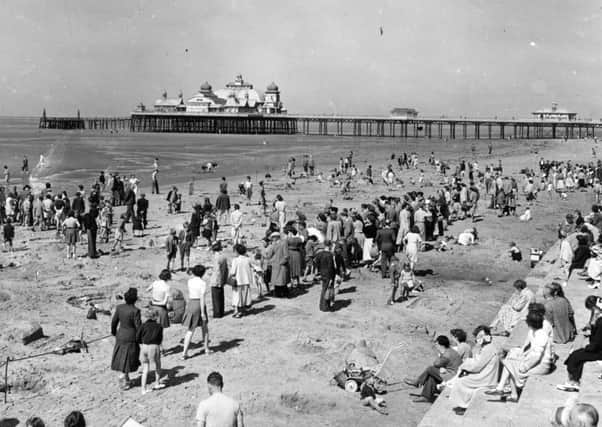 Sandcastle competition on St Annes beach in hte 1950's, with St Annes pier in the background.  The pavilion on the end was destroyed by fire in the 1970's.