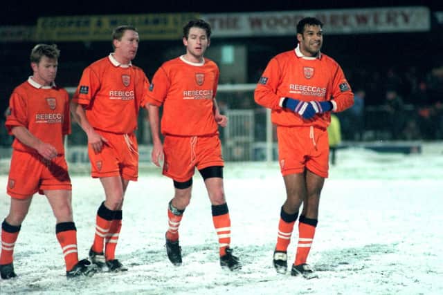 Happy Blackpool players walk off the snow-covered pitch after winning at  Shrewsbury on New Years Day