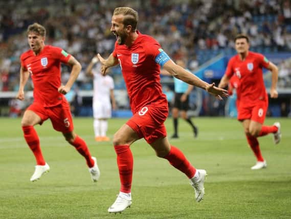 England's Harry Kane, centre, celebrates scoring his first of two goals in their 2-1 win over Tunisia (Picture: Owen Humphreys/PA Wire).
