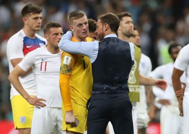 England goalkeeper Jordan Pickford is consoled by England manager Gareth Southgate after losing the FIFA World Cup, Semi Final.