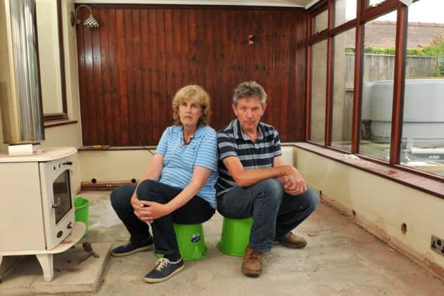 Paula and Stephen Simpson in their empty home, which is at the centre of a dispute with insurers