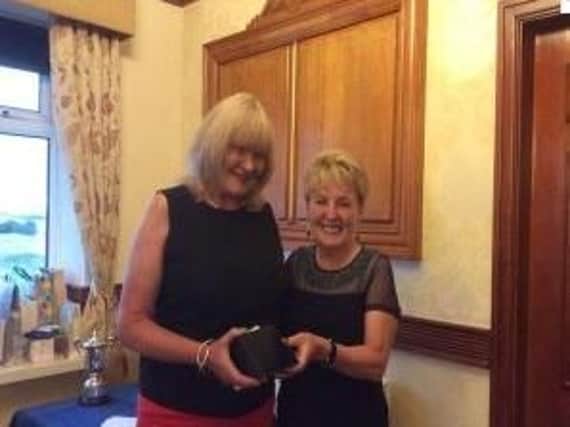 Sandy Beech accepts the Captain's Prize from Jackie Halstead at St Annes Old Links.
