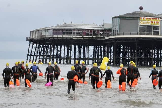 The swimmers enter the water at the North Pier, Blackpool