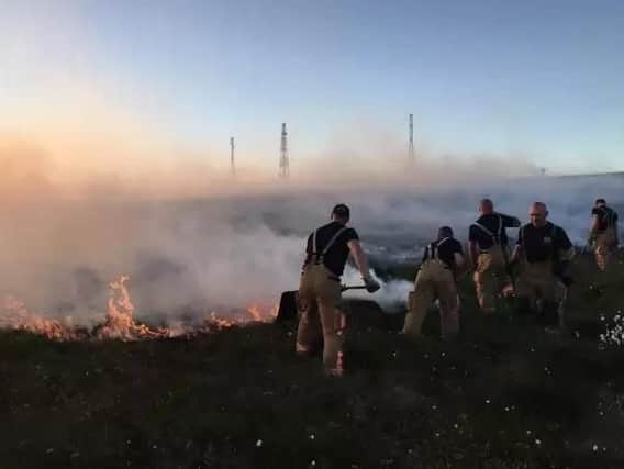 Lancashire firefighters continue to tackle the fire at Winter Hill