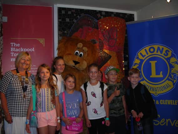 Fleetwood and Cleveleys Lions president Margaret Purcell with youngsters from Chernobyl at the Tower Circus.