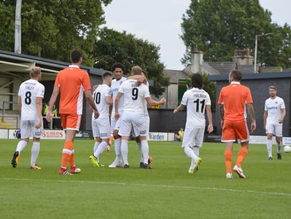 Danny Rowe is congratulated after giving Fylde the lead. Photo: Steve McLellan