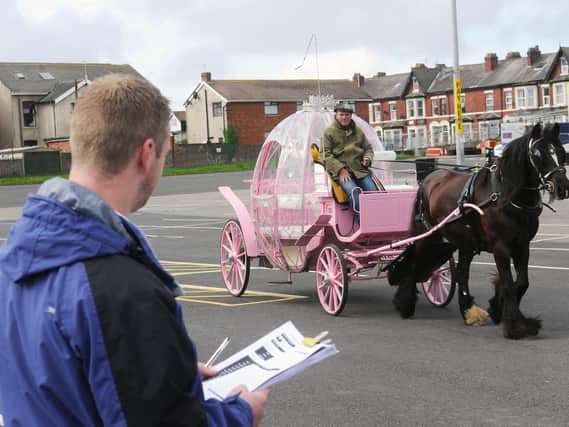 A Cinderella carriage being inspected by a town hall licensing officer