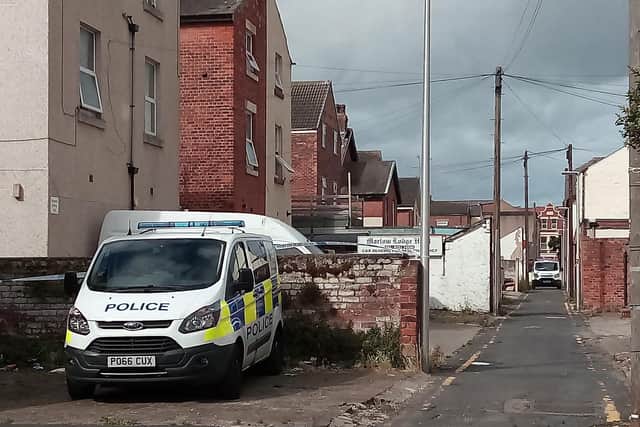Police in the alleyway behind Station Road this morning
