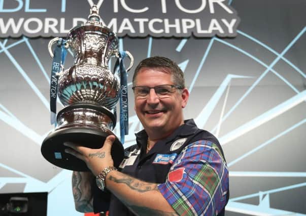 Gary Anderson shows off the Phil Taylor Trophy      Picture: Lawrence Lustig/PDC