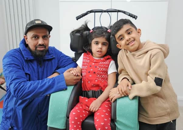 Saffa Shehzan (centre) with dad Majid and brother Isa, seven.