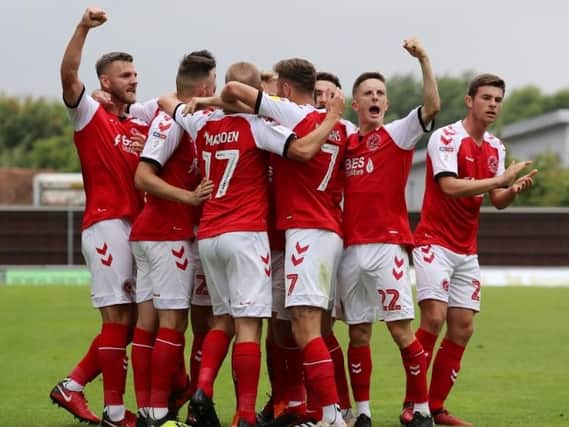 The Fleetwood Town players celebrate after Paddy Madden makes it 2-0 at Oxford United