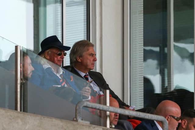 Owen Oyston watches on from the director's box with Jonathan Disley sat in front