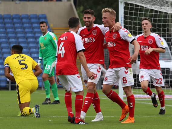Ched Evans, Kyle Dempsey and Jason Holt celebrate Fleetwood's first goal at Oxford
