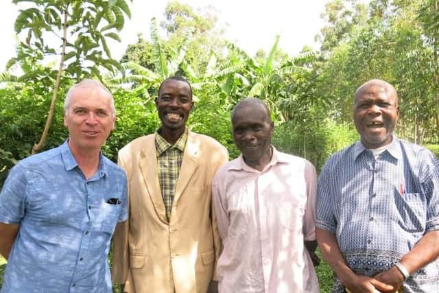 Alan Whelan with Pastor Vitalis, village elder Philip Malimu Tosi, and headmaster Mr Bondi