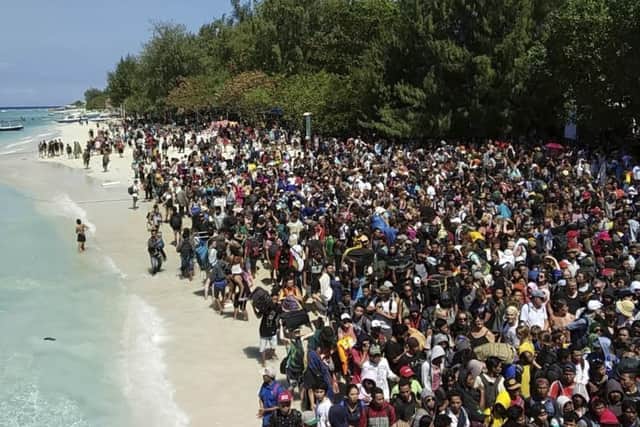 People were pictured desperately trying to get away from the island