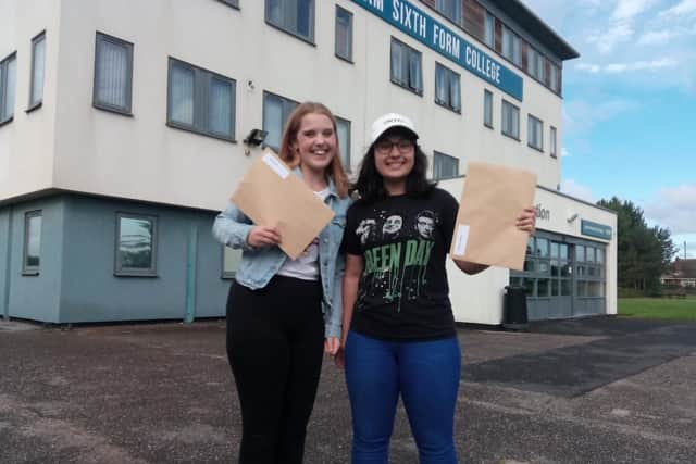 Kate Hughes and Dianelys Santos collect their A-levels results
