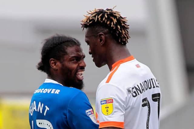 Armand Gnanduillet tussles with Shrewsbury's Anthony Grant