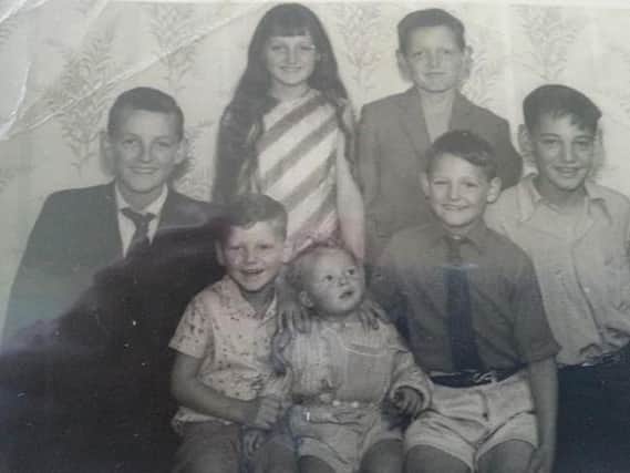 David, left, with some of his younger siblings when he was 16.