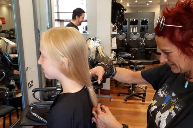Charlotte says goodbye to her locks with the help of hairdresser Wanda Dalby.