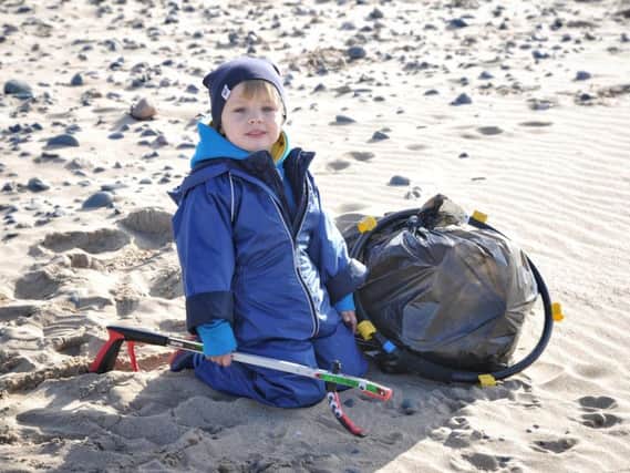 Young volunteer Jack Lovatt (3) Surfers against Sewage beach clean at Blackpool  South Shore Beach. Picture by Julian Brown