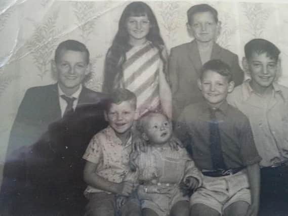 David, left, with some of his siblings.