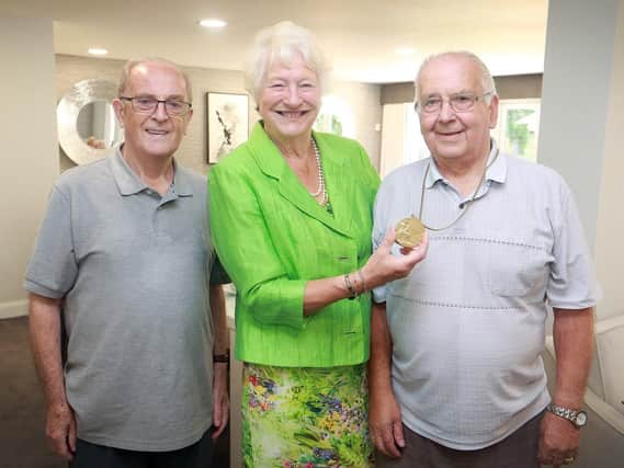 Dame Mary Peters showing her medal to  Bill Taylor and Peter Neville, the owners of Burrstone Grange, Thornton.