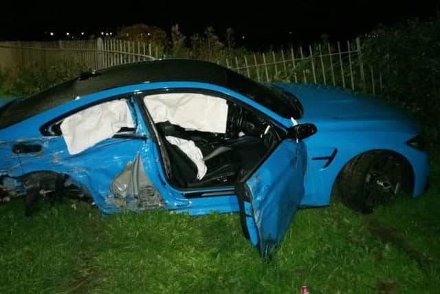 The wreckage of the BMW, from which two men, including the driver, fled, according to police (Picture: Lancashire Road Policing)