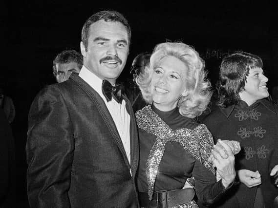 Dinah Shore and Burt Reynolds appear together in Los Angeles in 1971. Reynolds, who starred in films including "Deliverance," "Boogie Nights," and the "Smokey and the Bandit" films, died at age 82, according to his agent