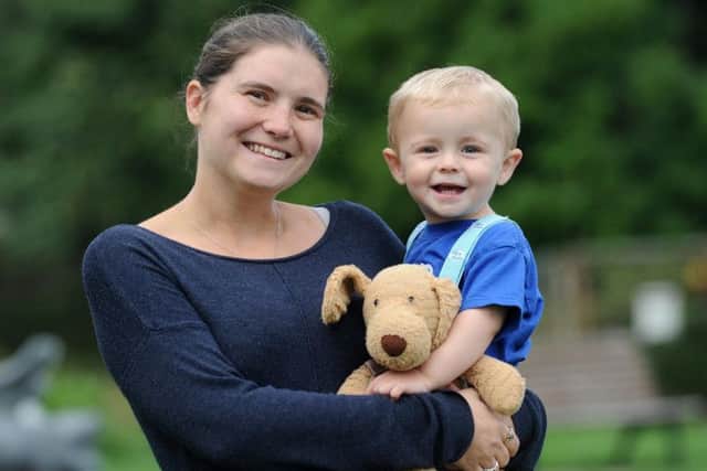 21-month-old George Lonsdale has been raising money for charity by doing a sponsored slide.  He is pictured with mum Jessica Lonsdale.