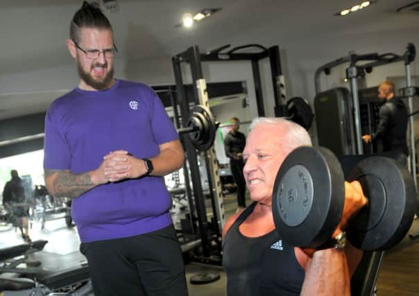 BEG - BLACKPOOL  24-08-18
Personal trainer Neil Scurrah, left, with Eric Munro, right, during Neil's  24-hour personal training challenge, in memory of his dad Robert, to raise funds for Rosemere Cancer Foundation, held at the gym at sports centre, Ribby Hall Village,