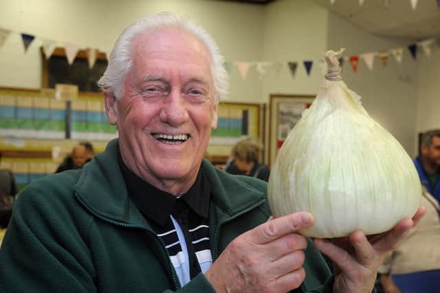 Mick McDowell proudly displays his winning Heaviest Onion in Show. Photo: ROB LOCK