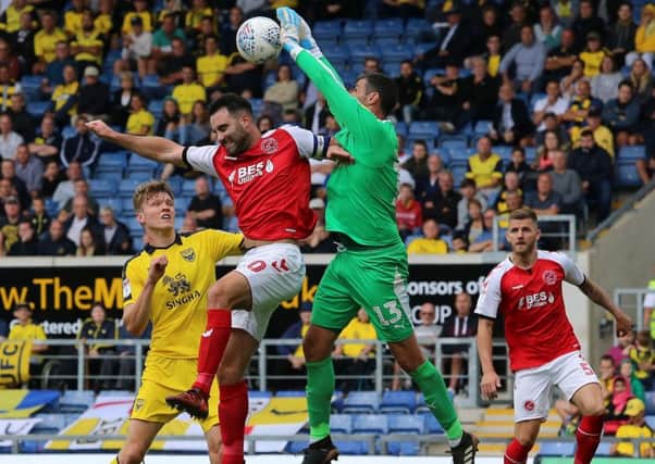 Oxford United's Scott Shearer claws the ball away from Fleetwood Town's Craig Morgan