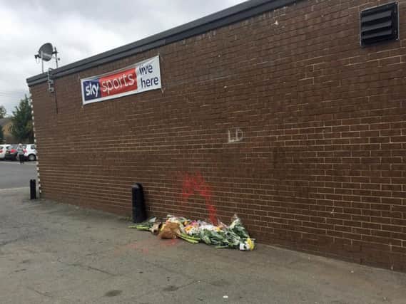 Flowers left at the scene where a homeless man was sprayed with paint in Normanby, Middlesbrough. The man was later found dead in a cemetery. Photo credit: Tom Wilkinson/PA Wire
