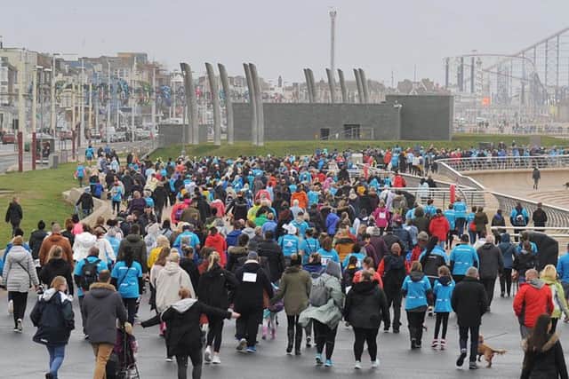 Walkers throng the promenade as they head towards South Pier